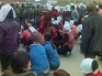 Residents of Dongzhou Township wear mourning white and kneel before armed police. Photo: The Epoch Times