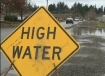 High water sign for flooded road