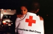 Red Cross volunteer carrying child