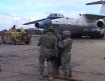 A C-130 aircraft, HUMVEE and soldiers is a typical site in Afghanistan.