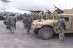 American officer looks back toward an International Forces vehicle near Mazur-e-Shariff, Afghanistan