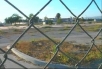 Looking through a cyclone fence at what was once a prominent Marine base: