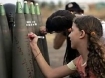 Israeli girls writing messages on shells of bombs that will be dropped on Palestinians