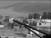 Taliban compound in the backgroundn from the ruins of a Soviet tank graveyard