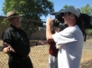 John Uldrich being interviewed by Tim King at MCAS El Toro, while Robert O'Dowd stands in the background.  All three are former El Toro Marines who write for Salem-News.com.