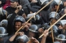 Egyptian police forces trying to crush the protesters.