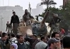 Image shows protesters who have climbed aboard a tank.