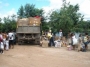 Residents of Kwakwani assisting Food for the Poor officials in the distribution exercise.