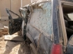 Military contractor truck that was severely damaged in an explosion in Iraq, probably a roadside bomb or IED.