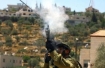 Israeli soldiers fires tear gas launcher at crowd.  This is all day every day here.