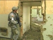 American soldier peers into an old Russian factory that is a ruin today, as much of war-torn Kabul is