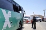 Israeli emergency personnel stand near a bus after it was ambushed north of the Red Sea resort of Eilat August 18, 2011