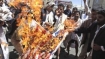 Yemenis burning the US flag during a demonstration