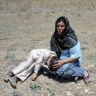 Afghan woman and child harmed from war