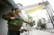 Fatah member stands guard at the entrance of the Palestinian refugee camp of Ain al-Hilweh