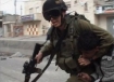 Image from “A People Without a Land” shows Israeli soldier dragging Palestinian boy in a headlock.