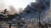 Smoke rises from burning houses around a mosque in riot-hit Meiktila in central Myanmar on Thursday