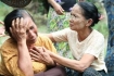 A Muslim woman comforts another who lost her home during recent violence in Thabyuchine village in Thandwe, Rakhine state