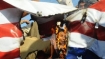 Pakistani Shia Muslims shout slogans behind a burning US flag during a protest in Lahore on March 2, 2012, against the killing of Shia travelers in the Kohistan area.