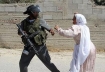 Palestinian woman standing up to Israeli soldier