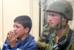 Israeli soldier arresting Palestinian child