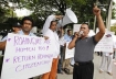 Ethnic Rohingya Muslim refugees from Myanmar hold placards and shout slogans during a rally in front of the US embassy in Bangkok on Wednesday, calling for international intervention. 