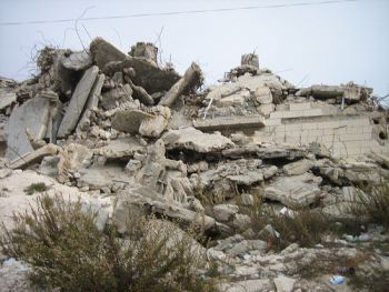 The remains of a 7-story Palestinian apartment building, one of over 22,000 Palestinian homes that Israel has demolished.