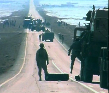 Oregon Guard crews change a tire blow out on an Afghanistan highway