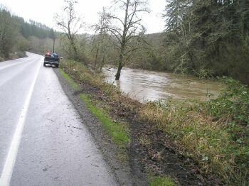 Tire tracks going into the Yaquina River showwhere the vehicle left Hwy 20.Photo Courtesy: OSP