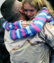 A daughter embraces her father returning from a previous Oregon National Guard deployment