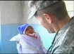 photo: Colonel Jim Lyman with a brand new citizen of Kabul.